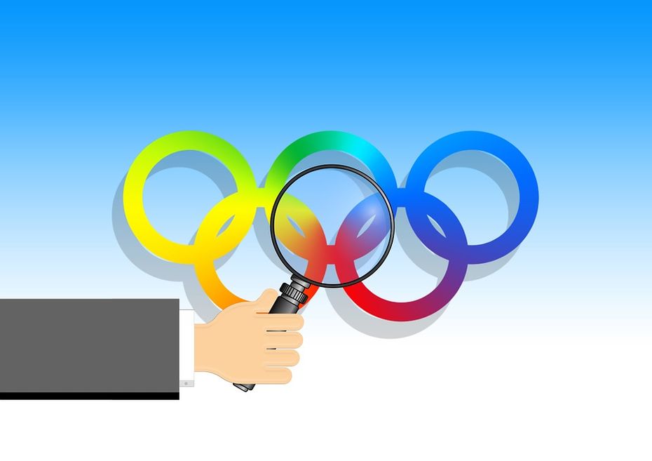 Zeichnung der olympischen Ringe unter einer Lupe